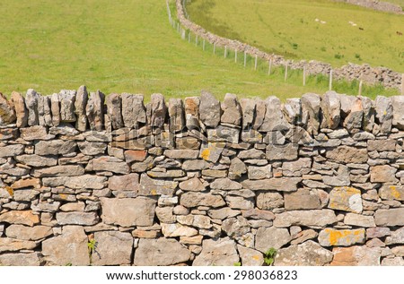 Dry stone wall traditional construction The Gower Peninsula South Wales UK with no mortar Royalty-Free Stock Photo #298036823
