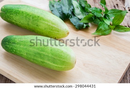 Fresh cucumber on wooden table background