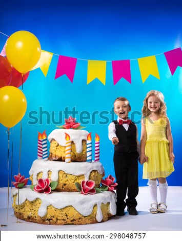 Girl and boy near a cake