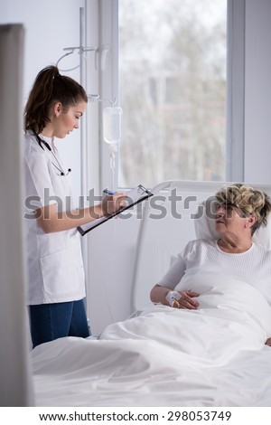 Professional young doctor during ward round in hospice