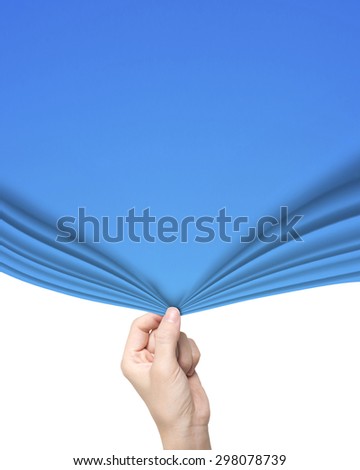 Woman hand pulling open blue curtain covering blank white background.