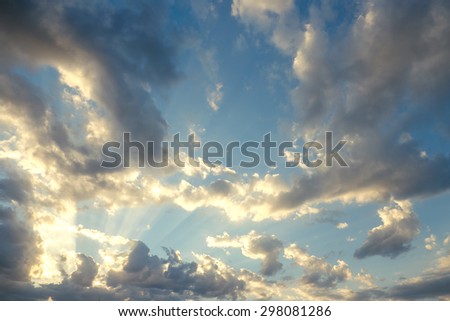 The sun beams through clouds on sky  