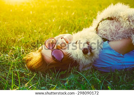 young woman and her dog having fun, copy space Royalty-Free Stock Photo #298090172