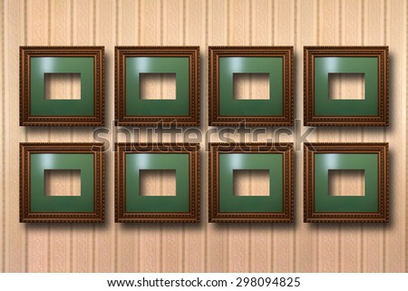 Gilded wooden frames for pictures on striped background 
