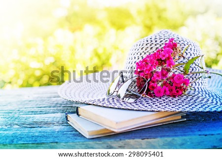 Vintage books with bouquet of field flowers/ nostalgic summer background  