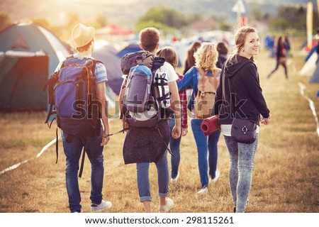 Group of beautiful teens arriving at summer festival Royalty-Free Stock Photo #298115261