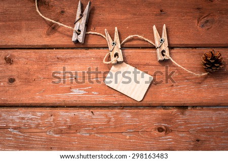 Sticker on clothesline with wooden clothespin. Wooden background. Christmas concept. Thanksgiving concept.  