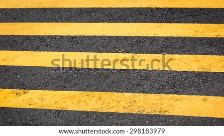 Crosswalk yellow lines on the road- pedestrian road crossing area