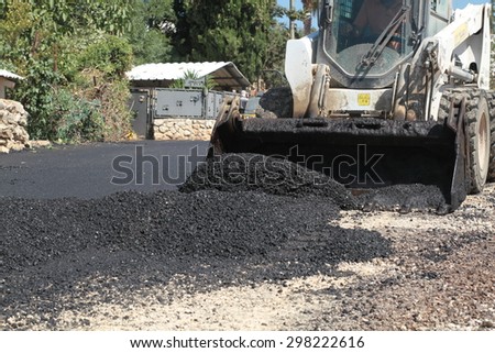 Road construction works with roller compactor machine and asphalt finisher