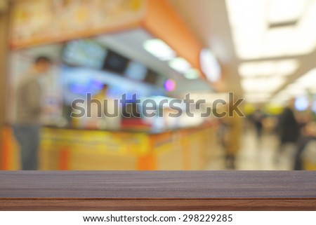 Empty wooden table and blurred cafe or restaurant with bokeh background, product display template