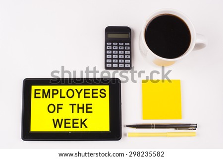 Business Term / Business Phrase on Tablet PC with a cup of coffee, Pens, Calculator, and yellow note pad on a White Background - Black Word(s) on a yellow background - Employees Of The Week