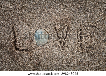 LOVE drawing in the sand on the beach