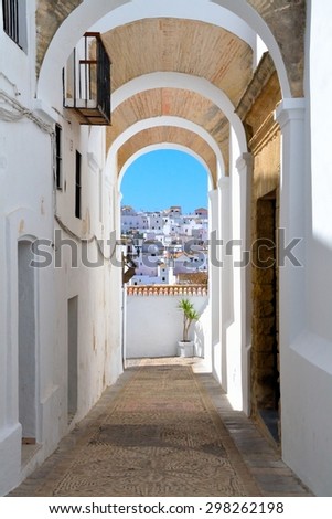 View of the skyline through the stone arches. Vejer de la Frontera one of the most beautiful white villages of Andalusia, Spain.