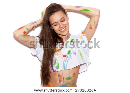 Young cheerful soiled in paint girl with long hair having fun. Smiling Woman with bright makeup and hairstyle on White background not isolated