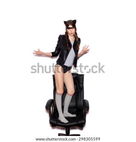 Funny girl represents as small cat.  Woman  with bright makeup hairstyle of girl with leather cat ears having fun. On white background not isolated
