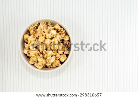 Caramel pop Corn in white blow on bamboo pad plate,Top view
