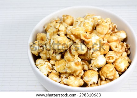 Caramel pop Corn in white blow on bamboo pad plate
