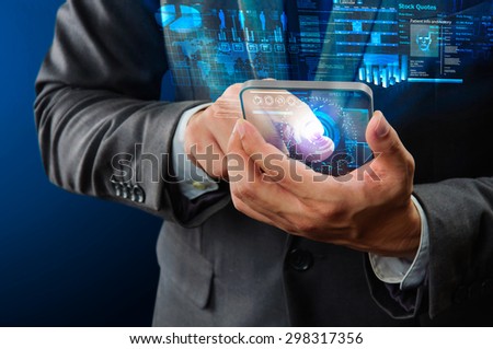 businessman using futuristic transparency mobile device 