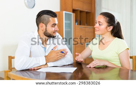 Young happy couple with documents indoors
