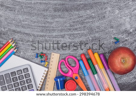 School supplies on blackboard 