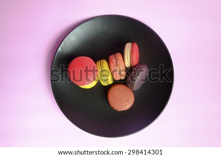 French macaroon and coffee cup on pink background