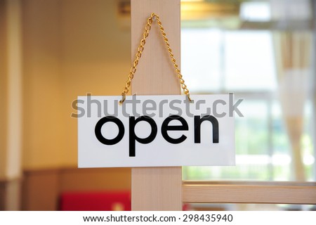open signboard on a door at coffee shop