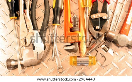 Close up view of many tools on a steel plate
