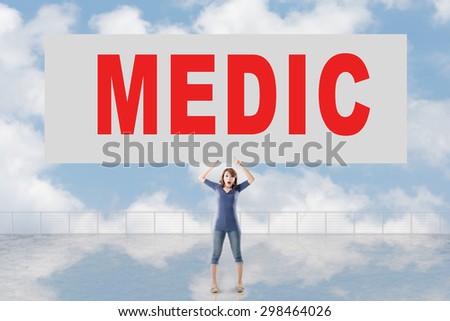 Woman holding card with text on it against the sky.