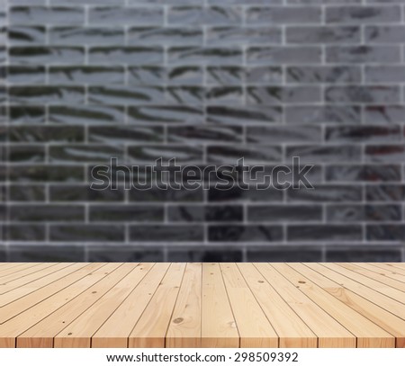 Empty wooden deck table with black wall background.