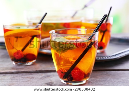 Fruity punch in glassware on metal tray, closeup