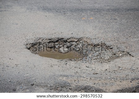 Damaged road  Royalty-Free Stock Photo #298570532