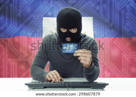 Dark-skinned hacker with credit card and flag on background - Haiti