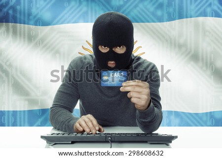 Dark-skinned hacker with credit card and flag on background - Argentina