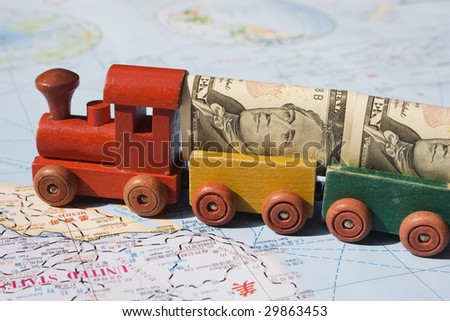 A toy train, loaded with US dollars going to North America.  The concept is trade between nations, international trade.  The map, is in English and Chinese.