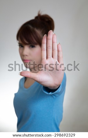 Asian women showing stop hand gesture, selective focus