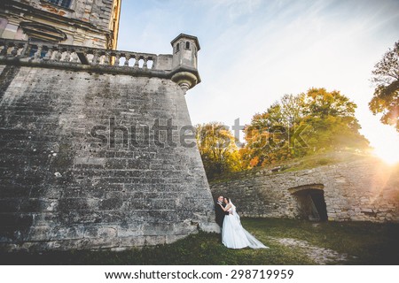 Amazing happy gentle stylish beautiful romantic caucasian couple on the background ancient baroque castle, Lviv