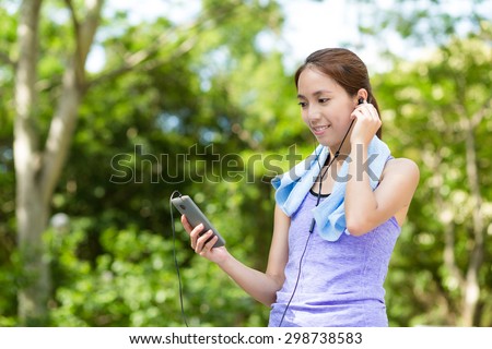 Asian Woman listen to music with cellphone