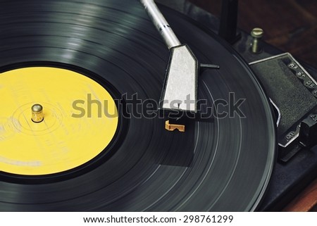 Record player stylus on a rotating disc, Picture of a vinyl record playing.