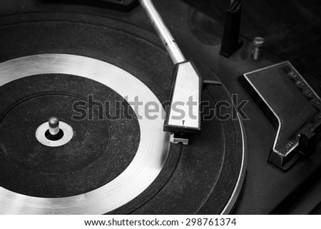 Record player stylus on a rotating disc, Picture of a vinyl record playing. ( Black and White )