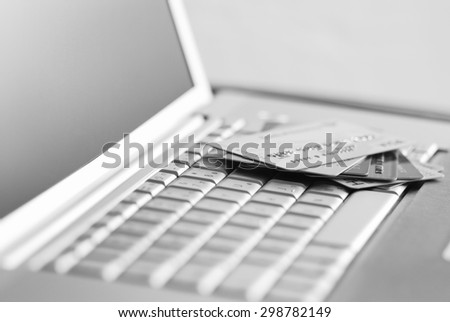 Credit cards on a laptop keyboard. Internet payment concept