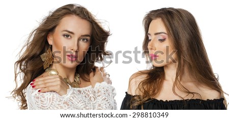 Glamorous portrait of two young beautiful woman isolated on white background