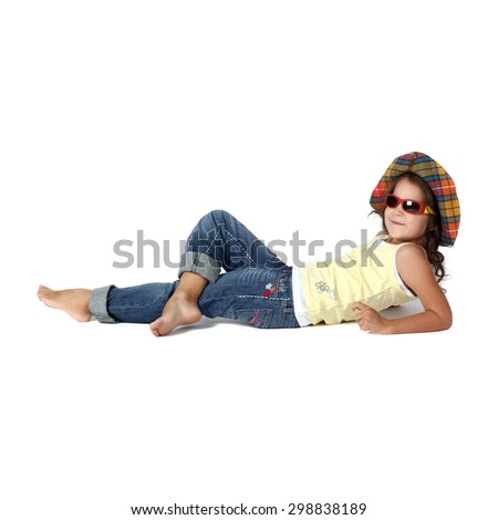 cute little girl in sunglasses and panama lying on the floor