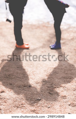 picture of man and woman with shadows of kiss 