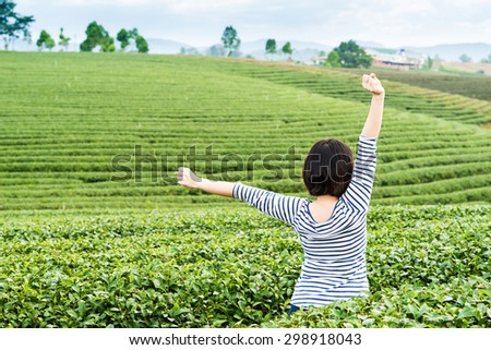 Happy girl in nice tea plantation scene