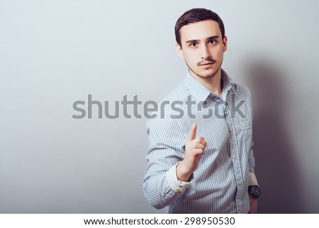 picture of a young businessman pushing an imaginary button