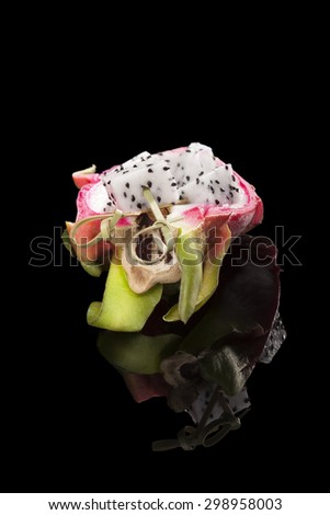 Dragon fruit isolated on black background. Tropical fruit salad.
