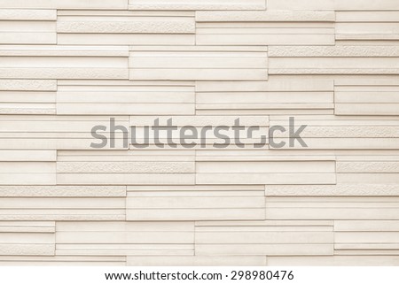 Granite tiled wall detailed pattern texture background in natural light sepia beige color





