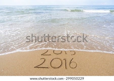 New Year 2016 is coming concept. Happy New Year 2016 replace 2015 concept on the sea beach Royalty-Free Stock Photo #299050229