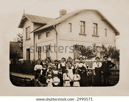 100 years ago - Very old photograph of a group of people in front of a house
