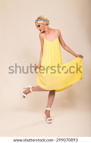 Tender girl in the yellow dress. Portrait beautiful girl in retro style. Hair and make-up in vintage style. Beauty, fashion photo